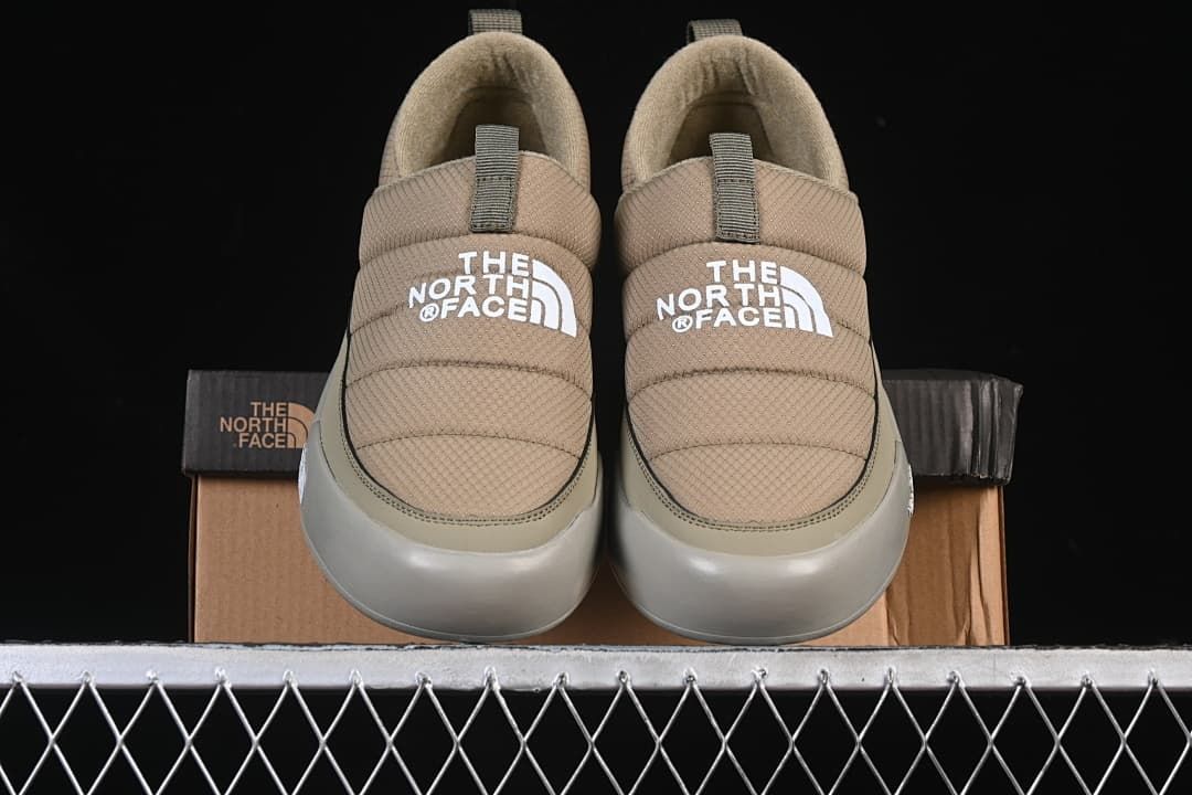 Front view of the pair of khaki slip-on shoes