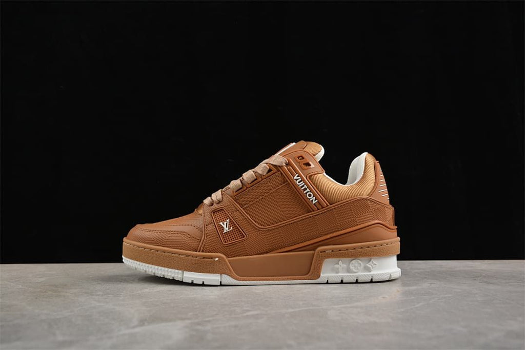 Side view of the brown sneaker with logo details and white outsole sections.