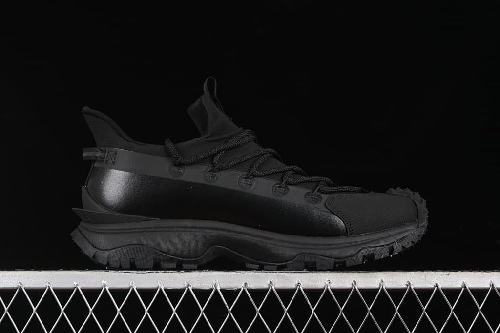 Side profile of the black outdoor sneaker