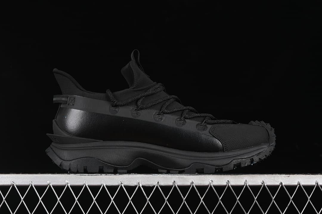 Side profile of the black outdoor sneaker