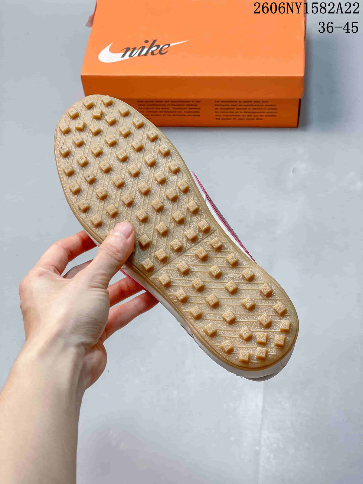 Underside of the sneaker showing a gum-colored outsole with raised tread.