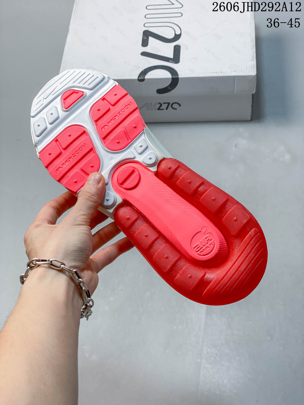 Underside of a Nike Air Max 270 sneaker showing a red and gray outsole