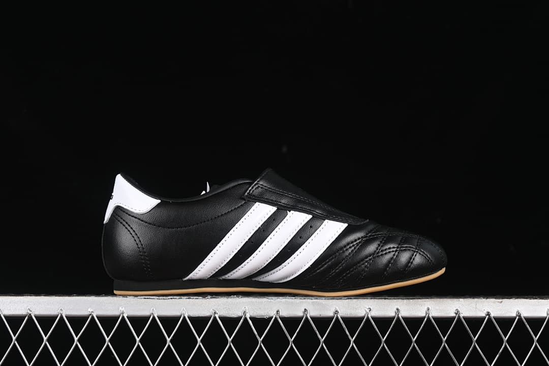 Side profile highlighting the black upper, white stripes, and low-cut shape.