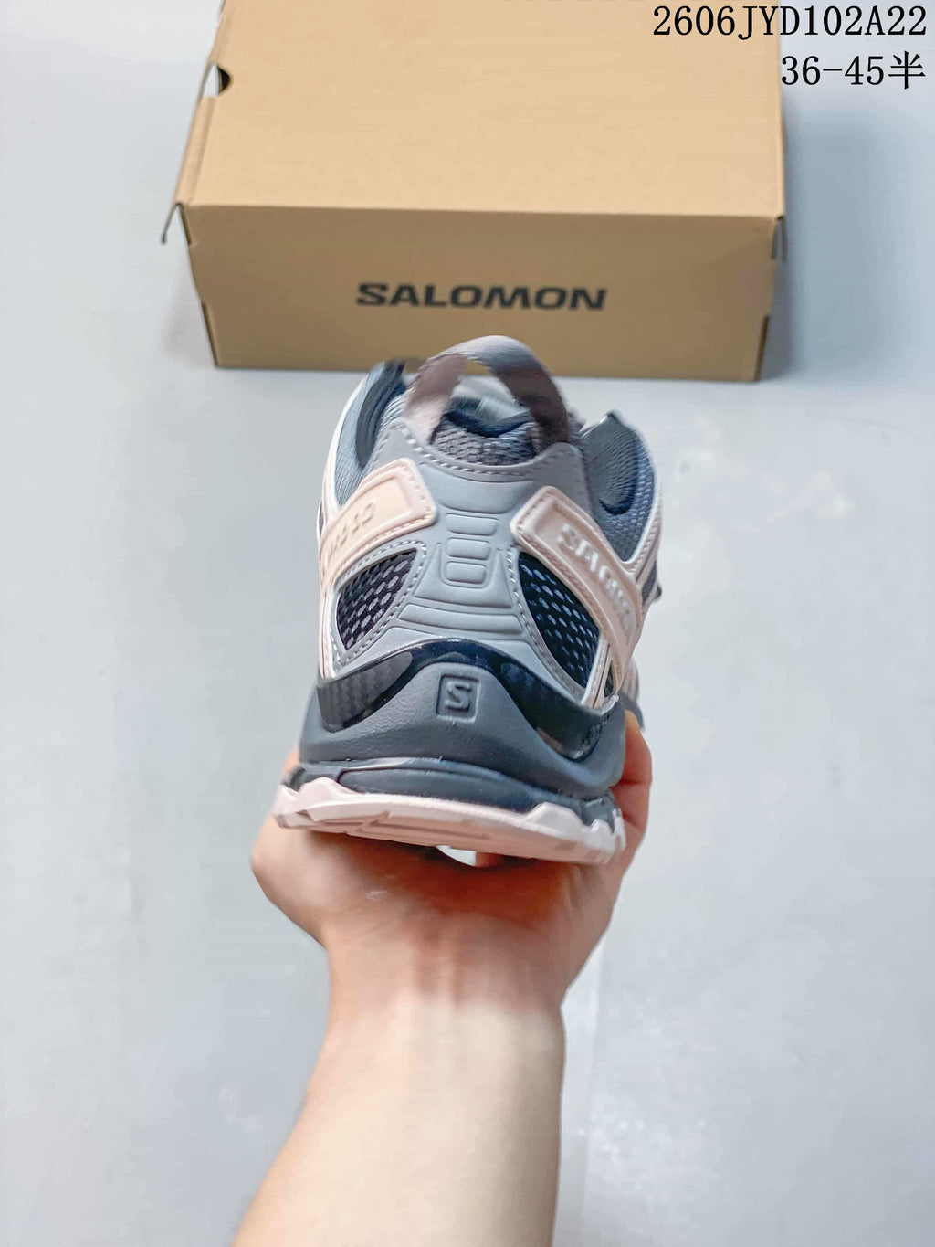Rear view showing the heel structure and mesh panels of a Salomon shoe