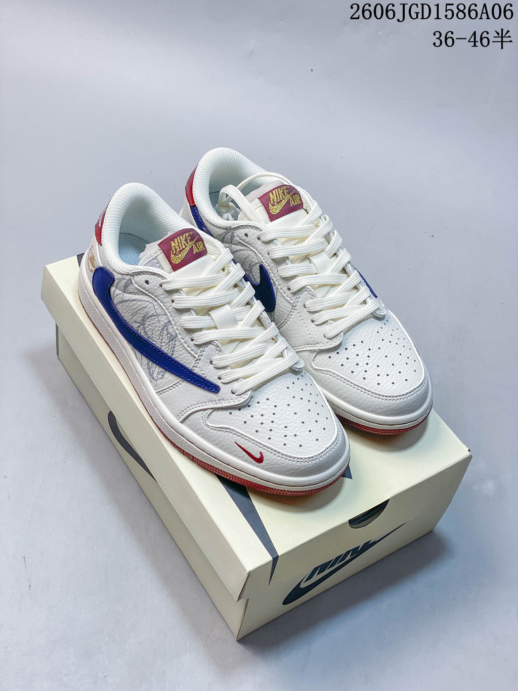 White and navy Nike Dunk-style sneakers with red accents, shown on a shoe box.