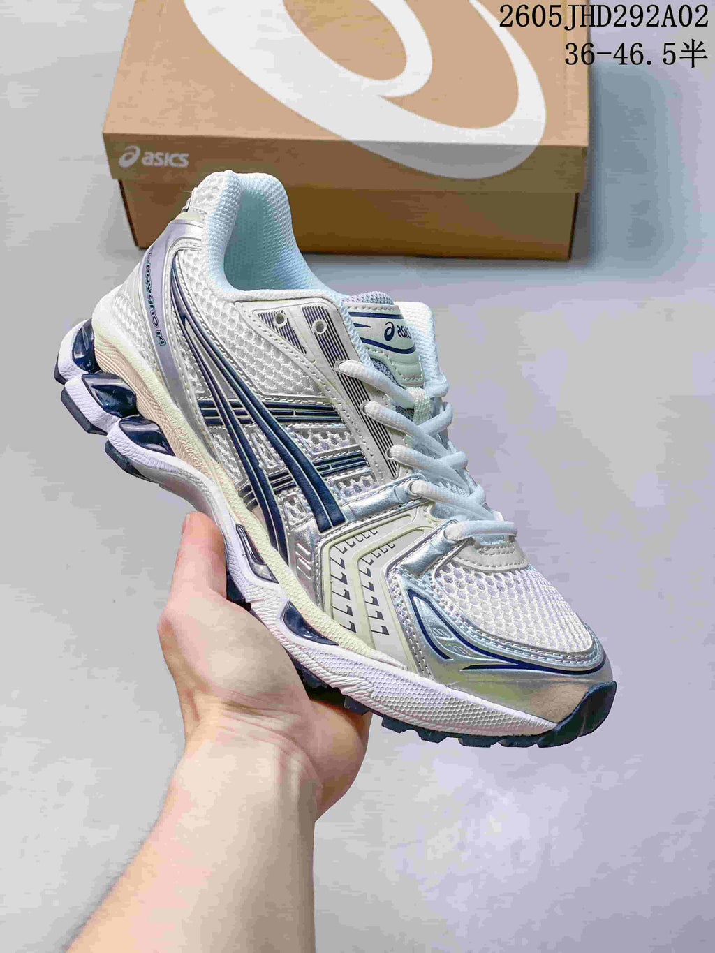ASICS GEL-KAYANO 14 sneaker in white and silver with blue accents