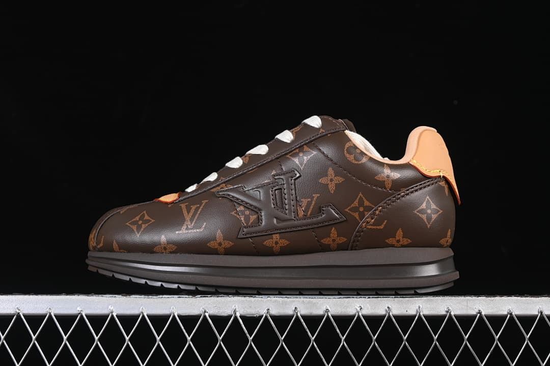 Side view of a dark brown patterned low-top sneaker with cream laces and tan accents.