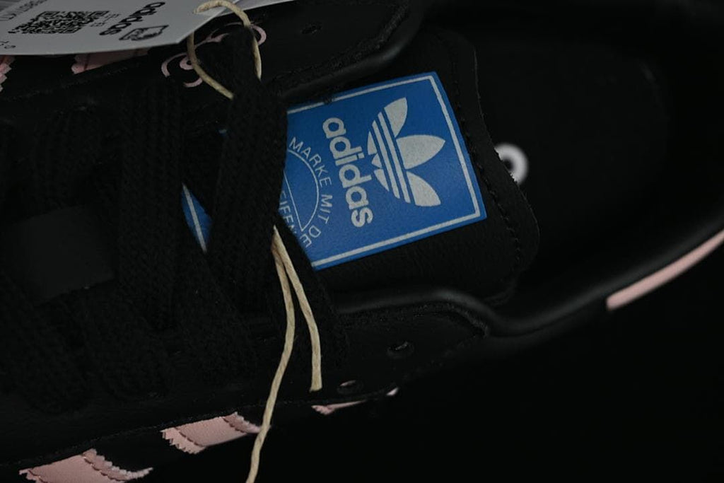Close-up of the blue adidas tongue label and black laces