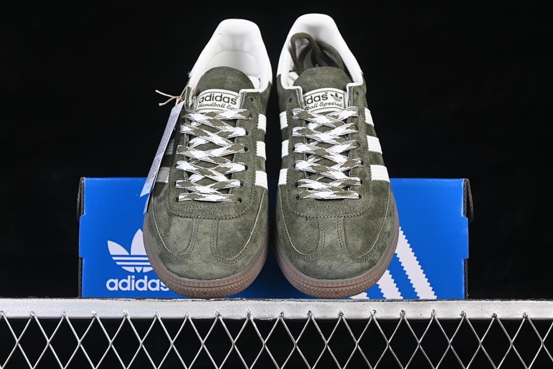Front view of the pair of green sneakers displayed on the box