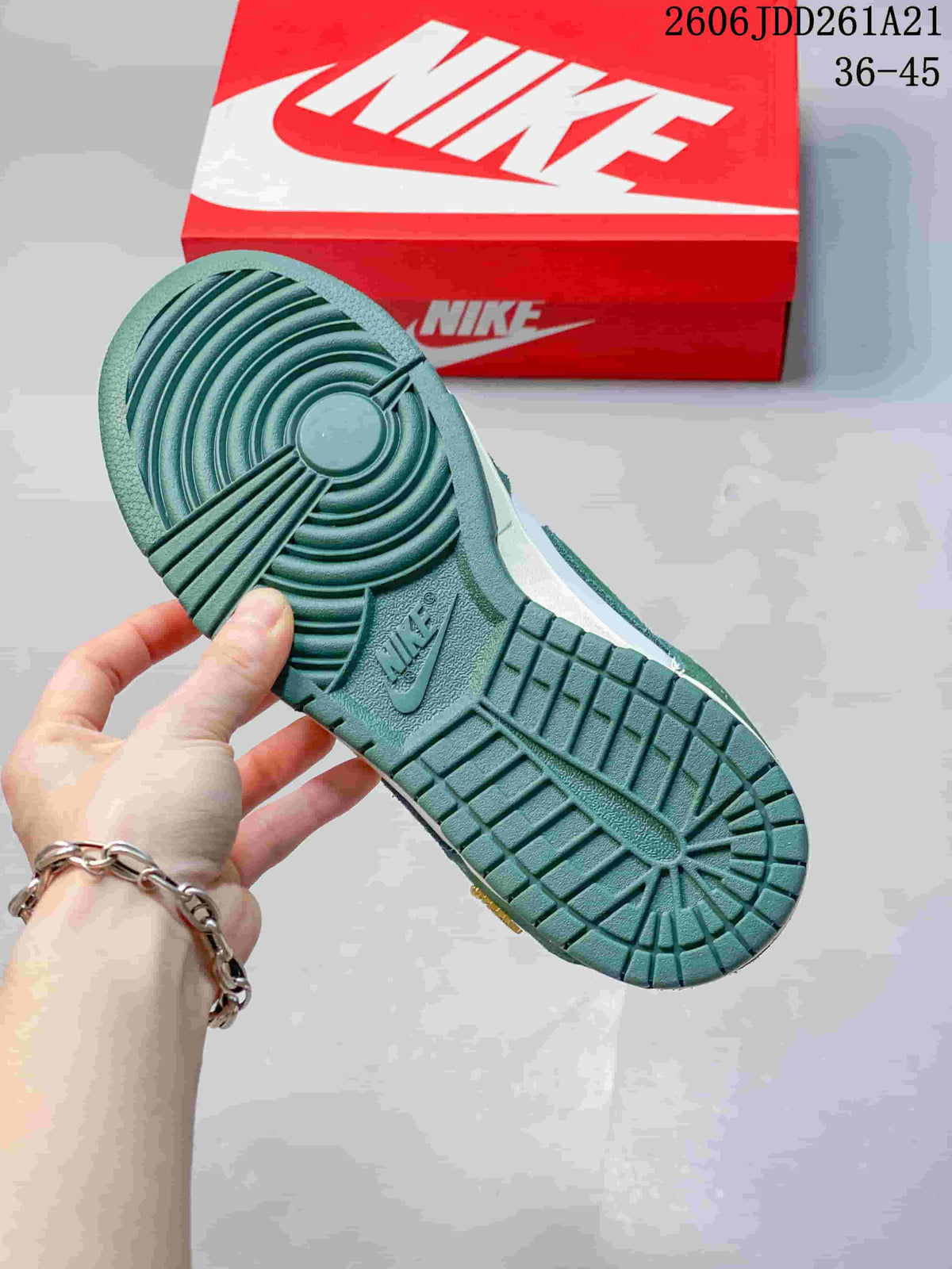 Close-up of the green patterned outsole on a Nike Dunk Low sneaker