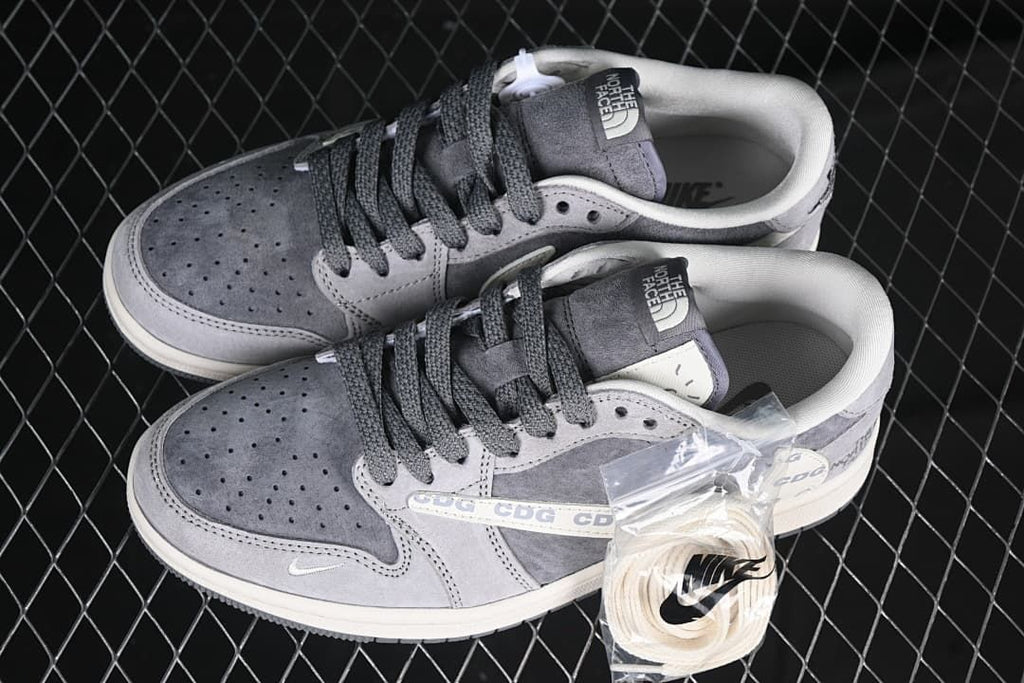 Pair of gray low-top sneakers with an extra set of light-colored laces