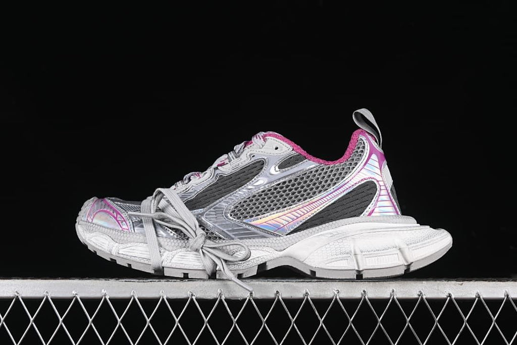 Side view of a grey, white and pink chunky low-top sneaker