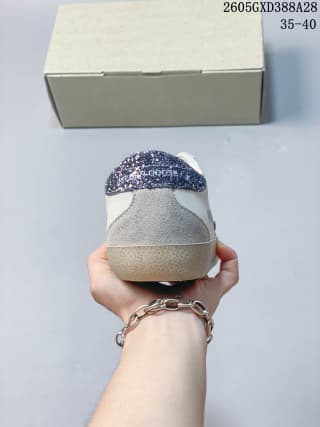 Rear view of a white and gray low-top sneaker with a glittery heel accent