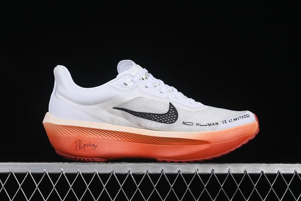 Side profile with white upper, black swoosh, orange sole and printed side text