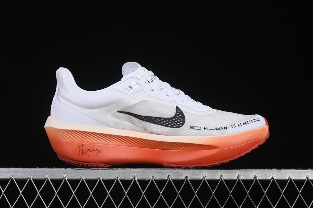 Side profile with white upper, black swoosh, orange sole and printed side text