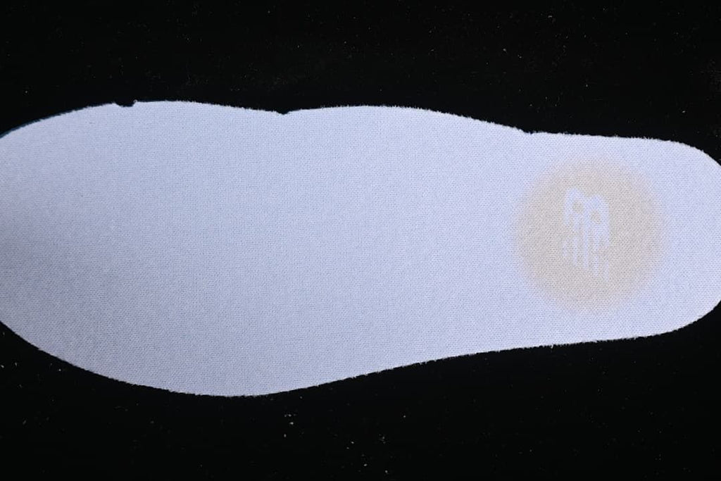Light-colored insole shown against a dark background.