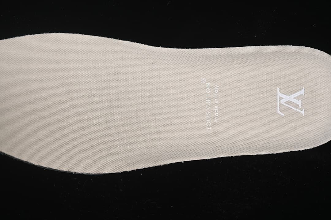 Close-up of beige insole with printed emblem