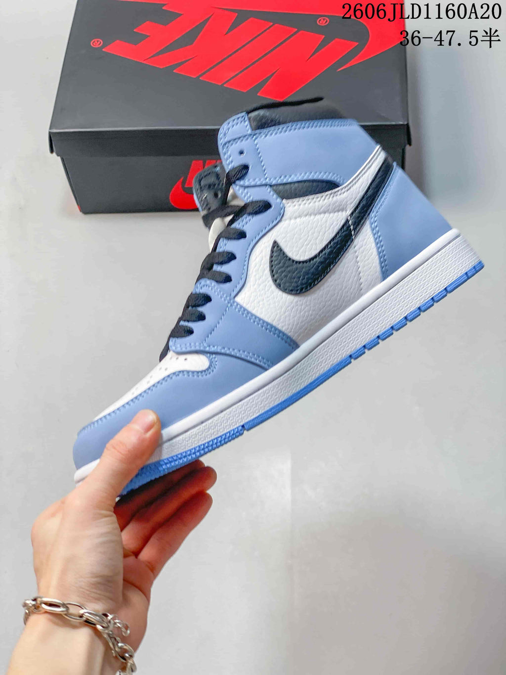 Side view of a blue, white, and black high-top sneaker