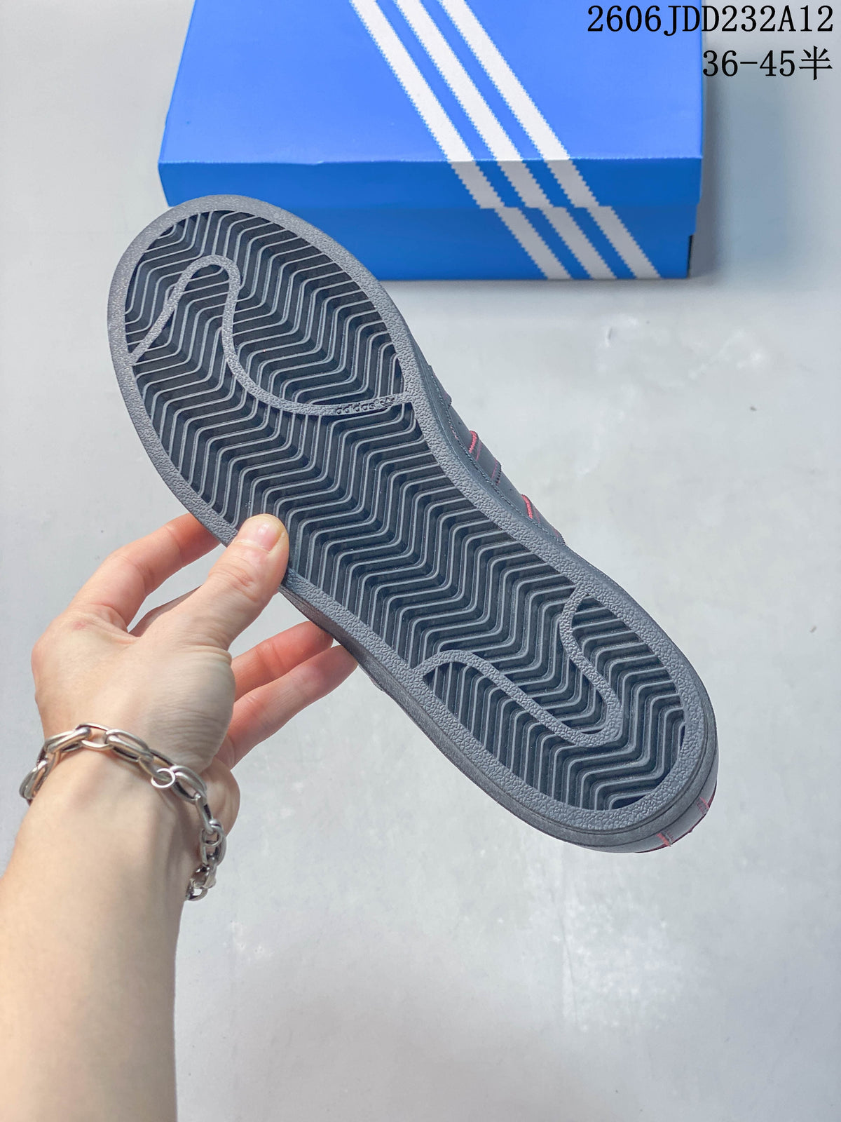 Close-up of the sneaker outsole showing a zigzag tread pattern.