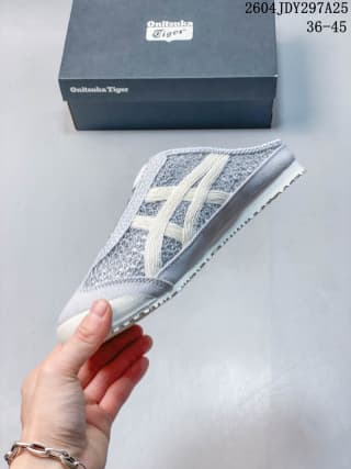 Angled side view of a grey and white Onitsuka Tiger Mexico 66 Sabot sneaker showing the slip-on construction and patterned outsole.