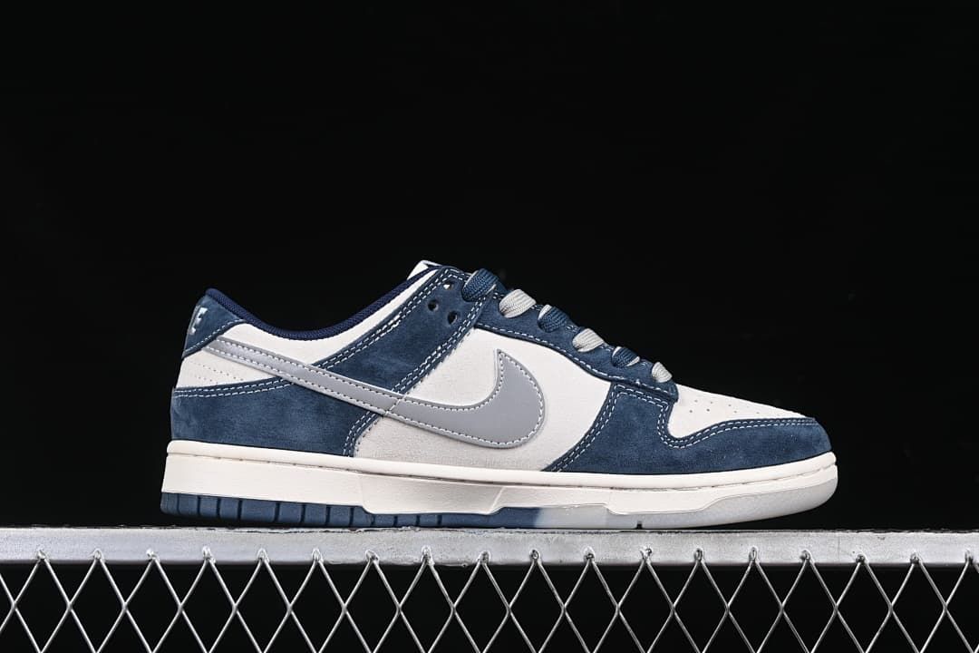 Side profile of a navy, white, and gray low-top sneaker