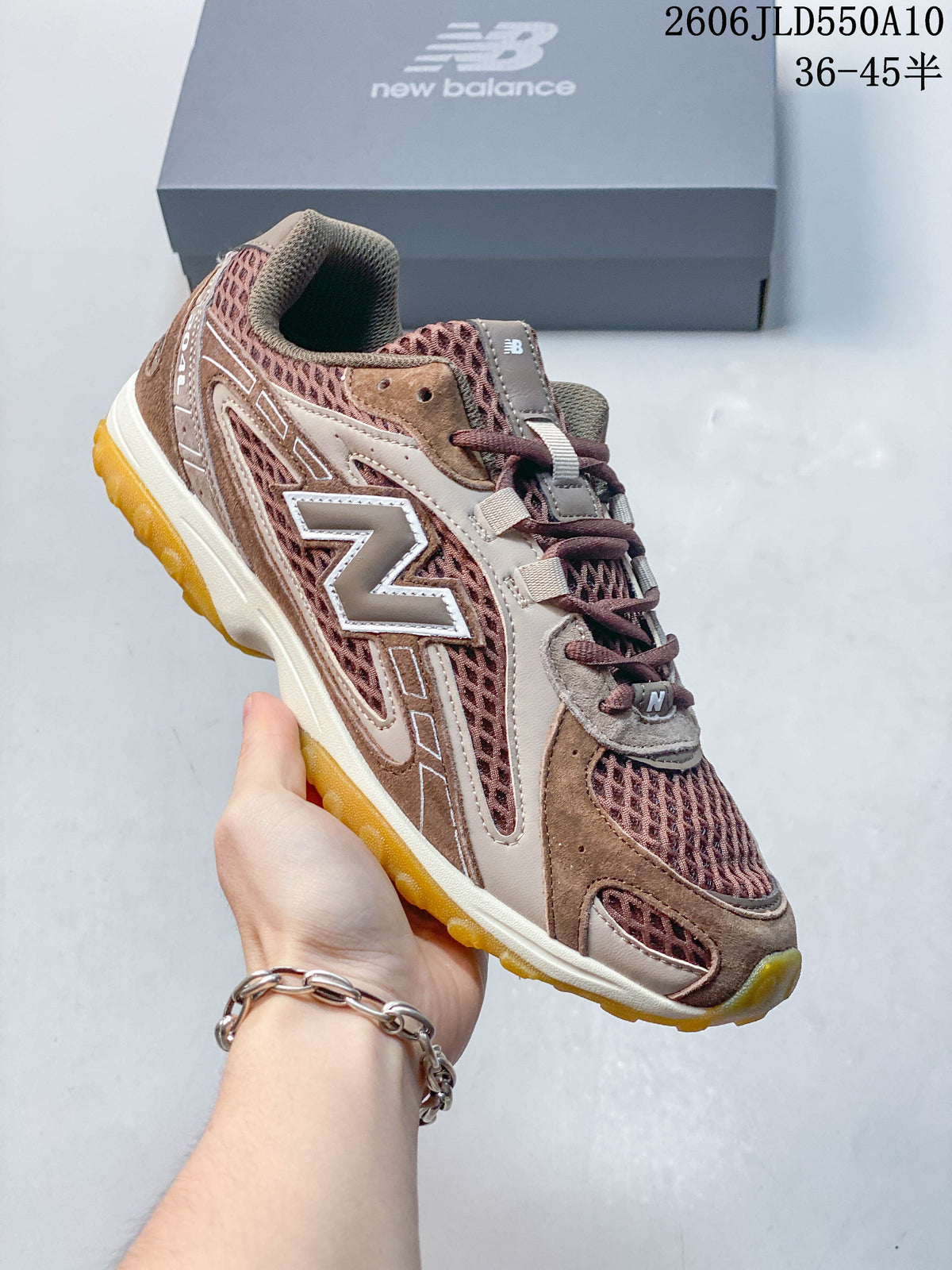 Angled side view of the brown and mauve New Balance 204L sneaker