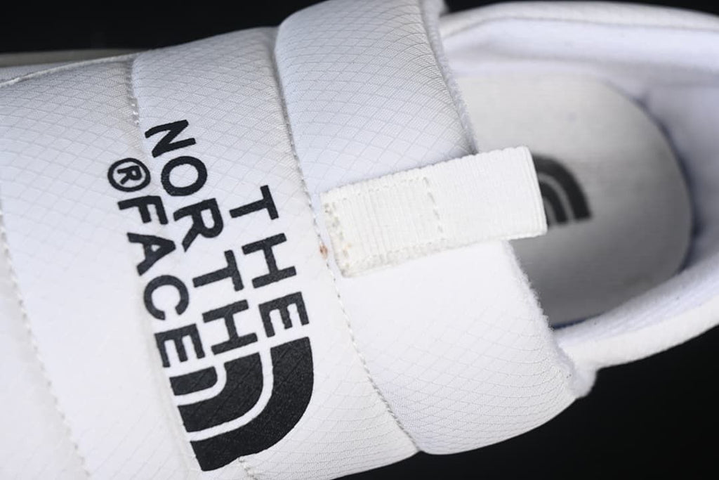 Close-up of the branded upper strap and front pull tab