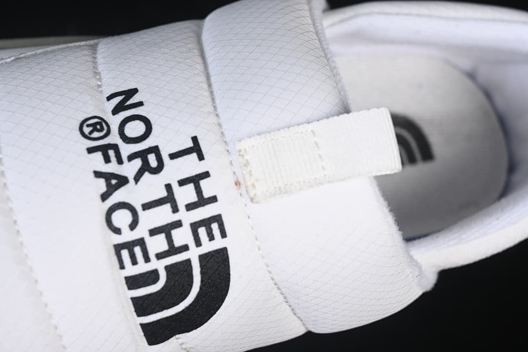 Close-up of the branded upper strap and front pull tab