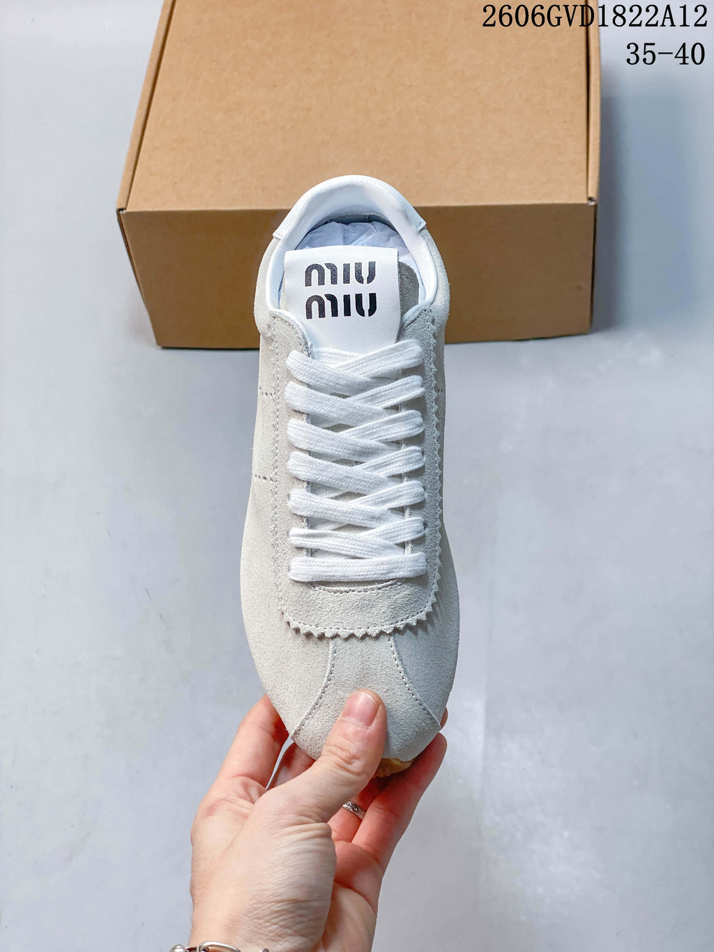 Top view of the sneaker showing white laces and logo on the tongue.