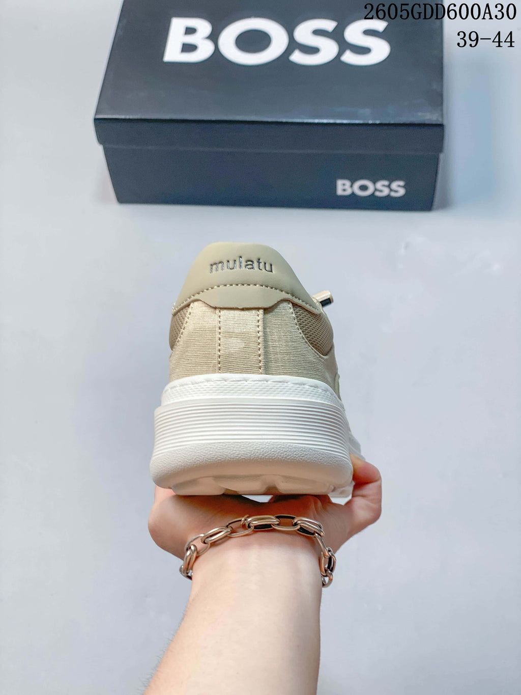 Rear view showing the beige sneaker heel and white sole
