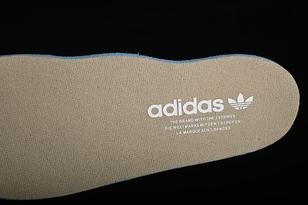 Close-up of a beige adidas-branded shoe insole