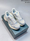 Pair of silver and pale blue ASICS GEL-1130 sneakers shown on a shoebox