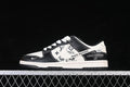 Side view of a cream and black low-top sneaker with printed panels and white laces