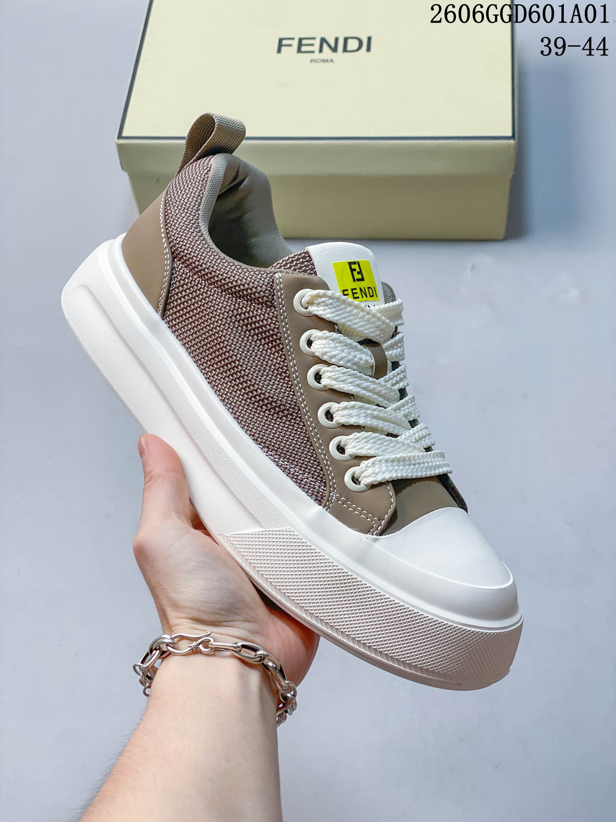 Angled view of a taupe and brown low-top sneaker with white laces and a thick white sole