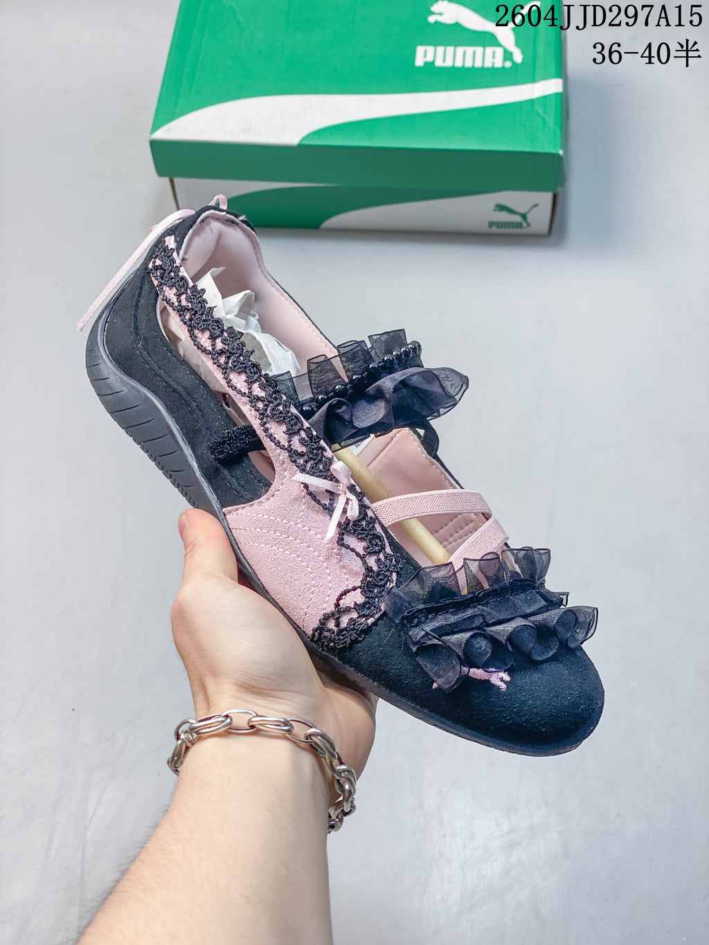 Side view of a black and pale pink embellished low-profile sneaker