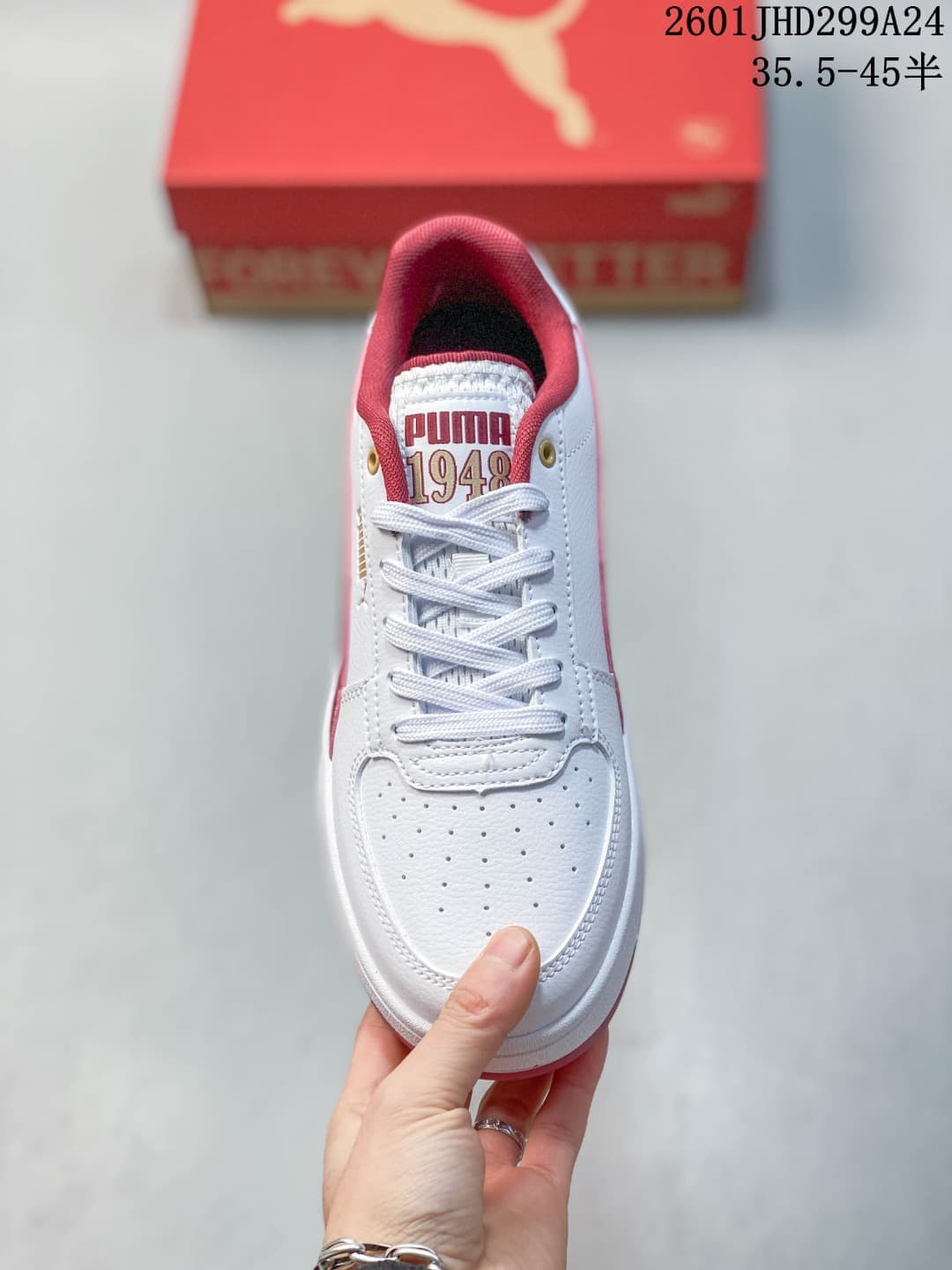 Top view of a white Puma Caven 2.0 sneaker showing its laces and perforated toe