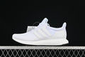 Side profile of white Adidas UltraBoost 1.0 sneakers against a dark background.