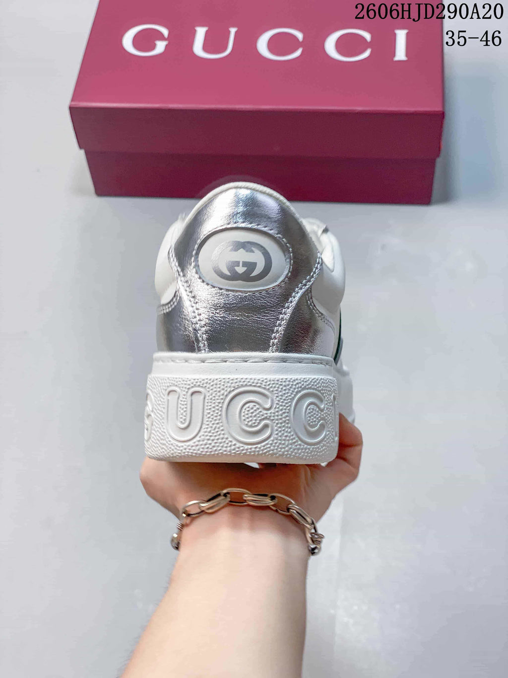 Rear view of the sneaker showing a silver heel panel and chunky white sole