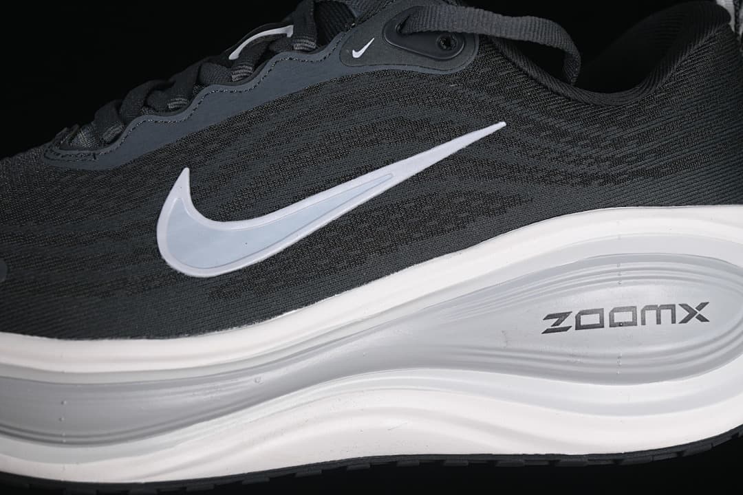 Close-up of the dark patterned upper, light-colored Swoosh, and midsole.