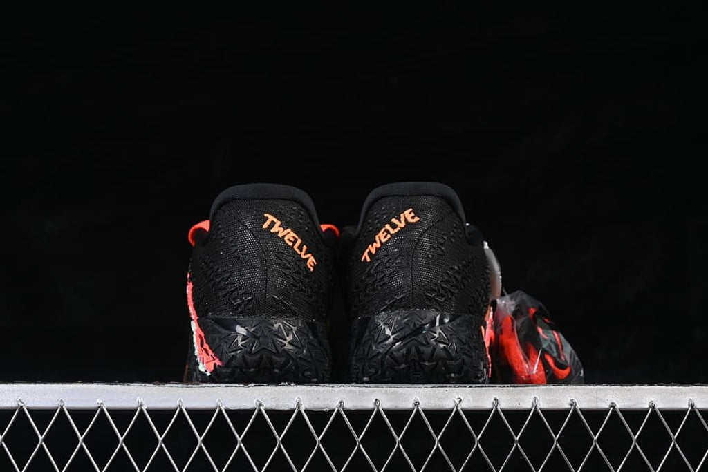 Rear view of the pair with orange Ja-themed heel lettering.