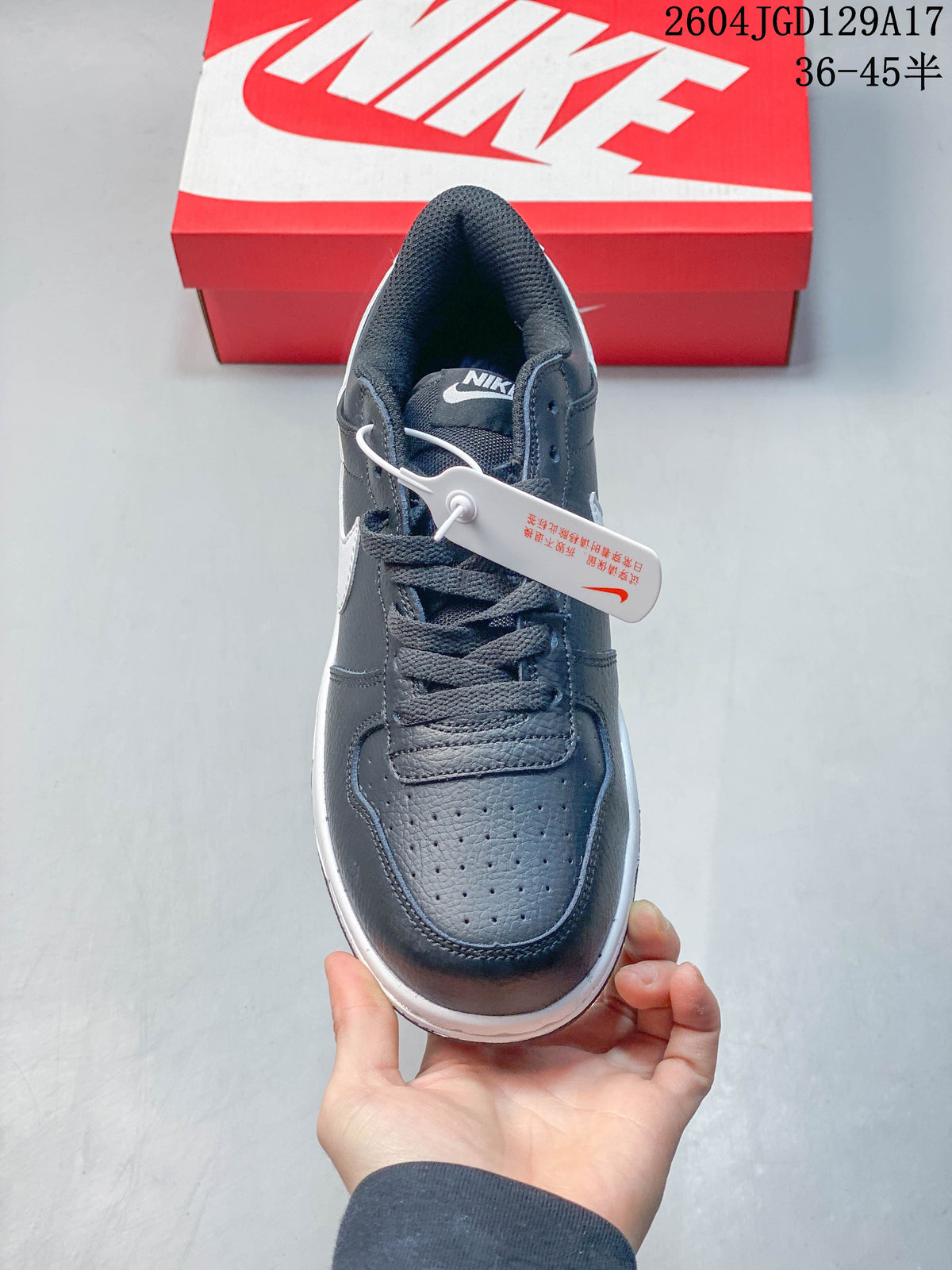 Front view showing the perforated toe and lace-up closure of a dark gray sneaker