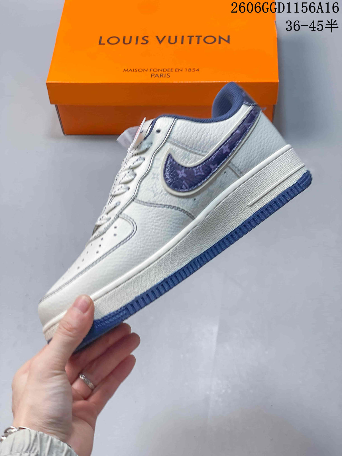 Side view of an off-white low-top sneaker with navy patterned accents