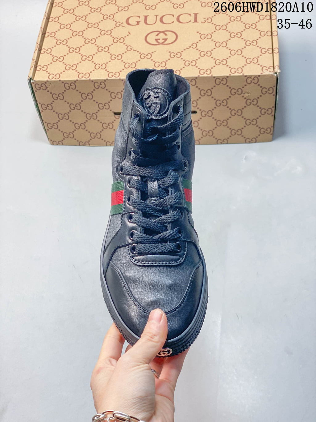 Front view of a dark gray high-top sneaker showing the laces and tongue logo.