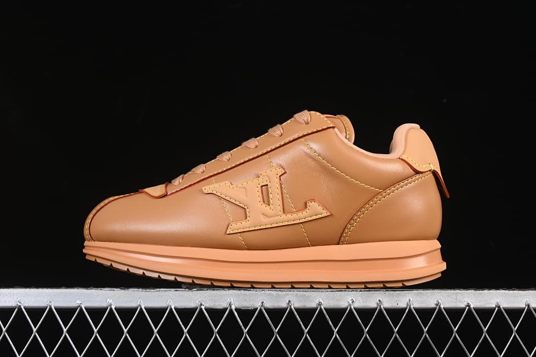 Brown low-top sneaker shown in profile with a raised side emblem