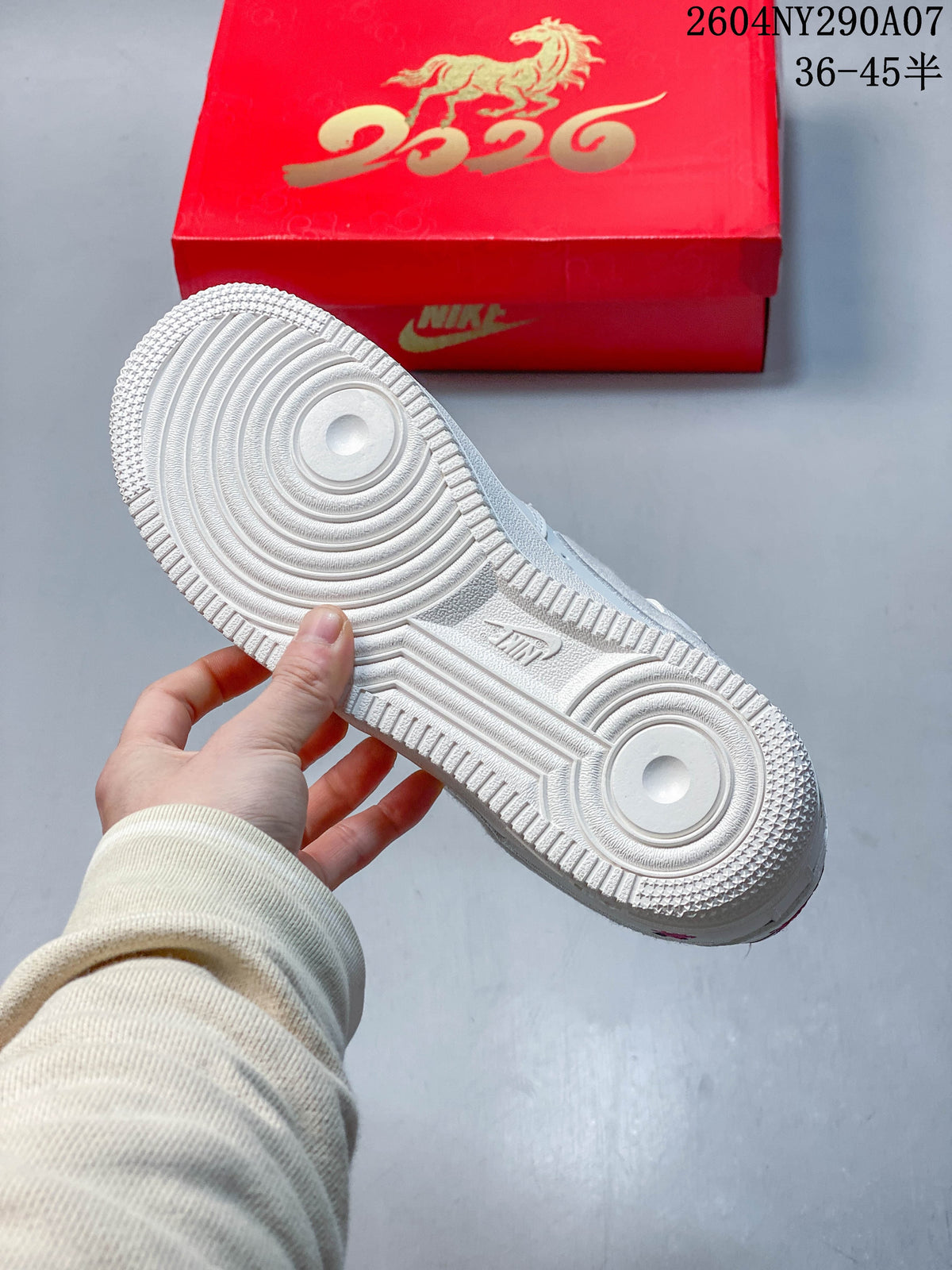 Underside of a white sneaker showing its circular traction pattern, with a red horse-decorated box behind it.