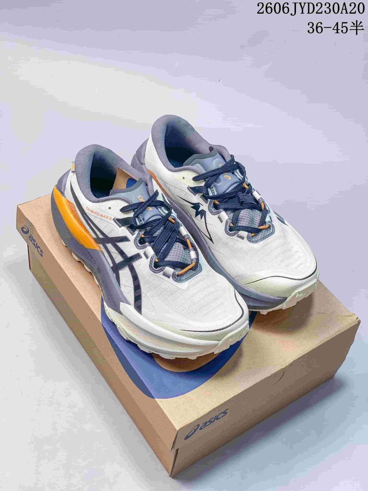 Pair of white ASICS GEL-TRABUCO MAX 5 shoes with gray and orange accents