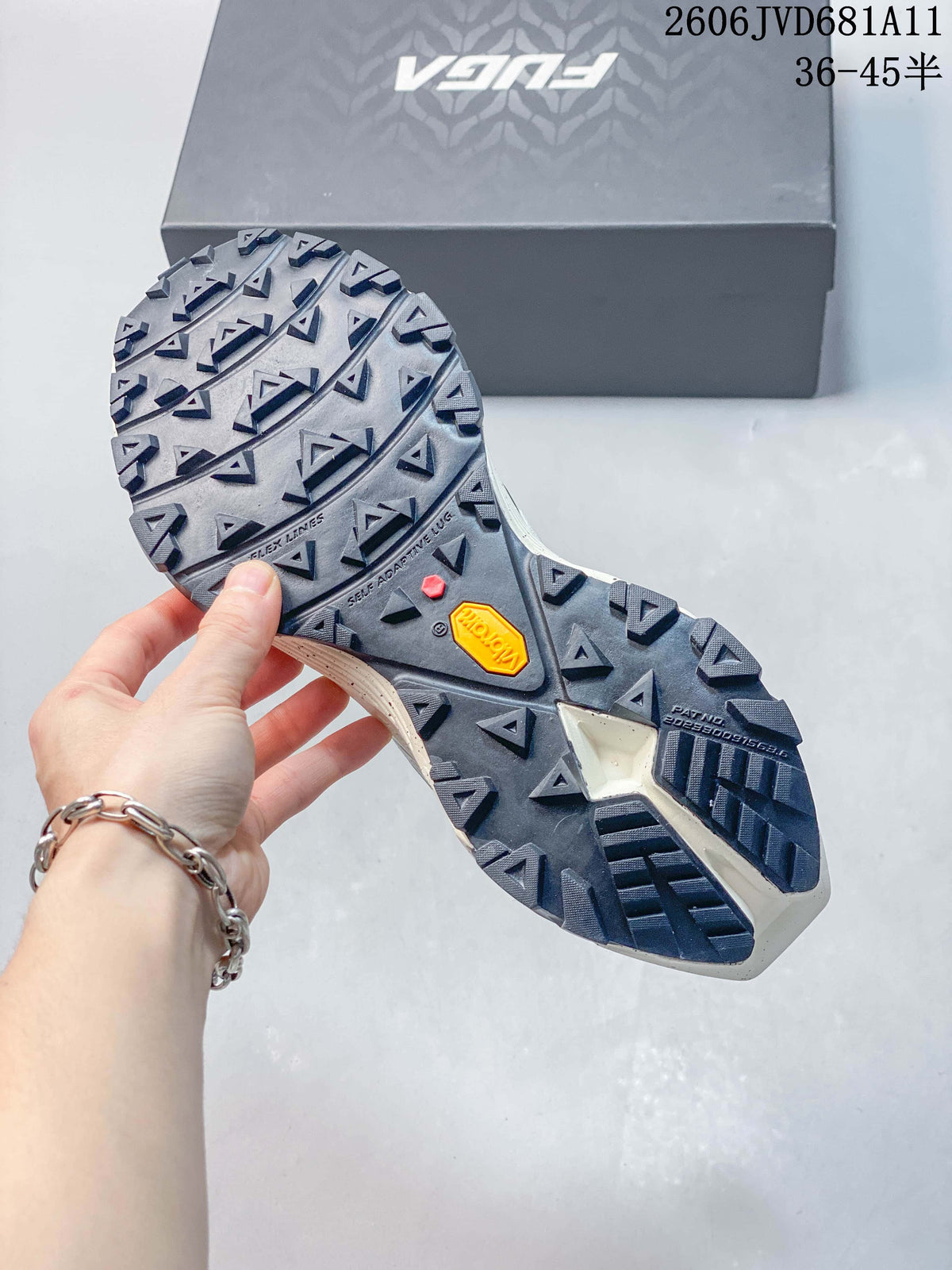 Close view of the trail shoe outsole with prominent lugs and a visible Vibram mark.