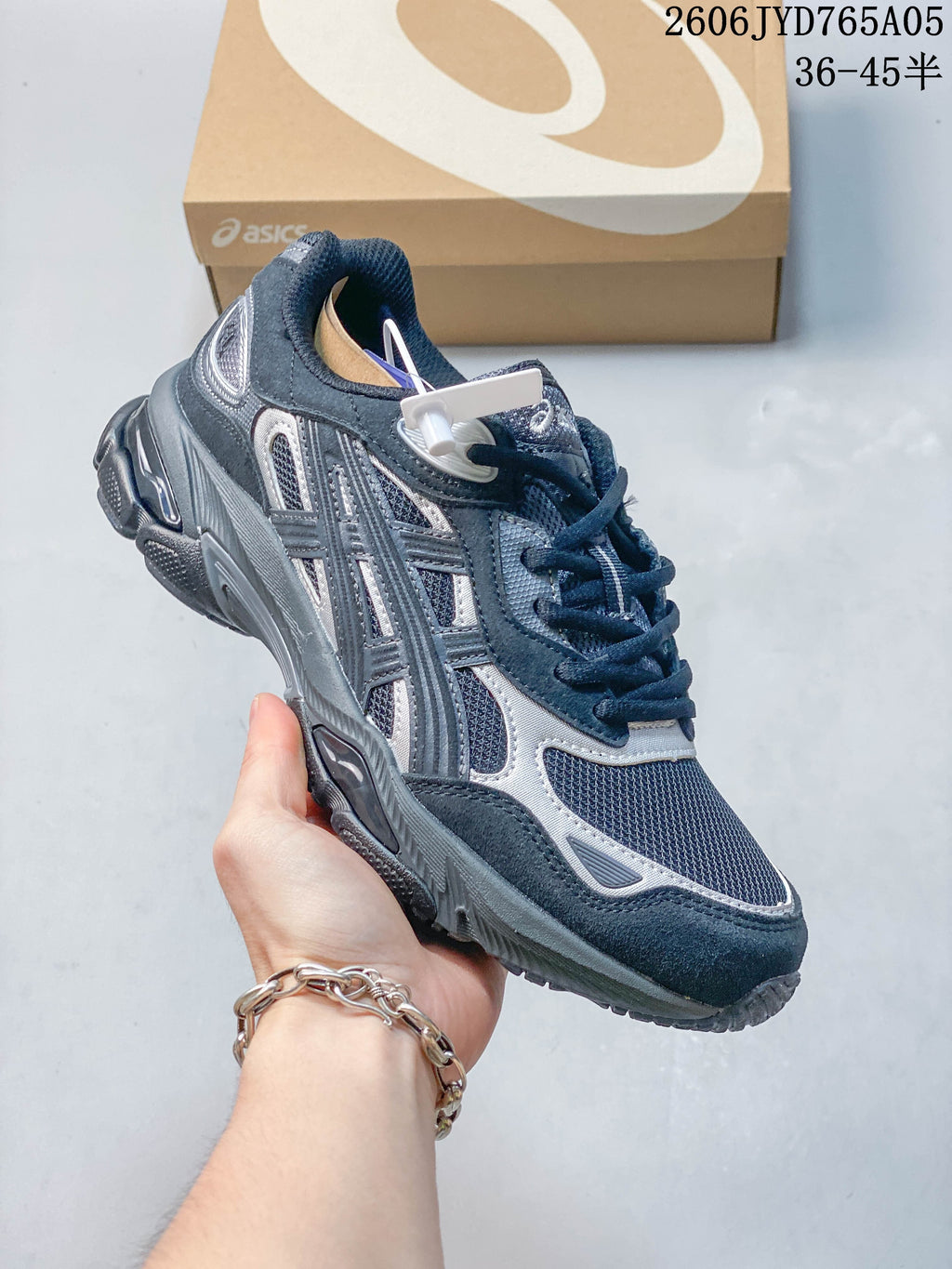 Angled side view of the dark blue and silver sneaker