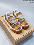 Pair of brown and yellow checkerboard low-top sneakers with white laces and contrasting brown outsoles