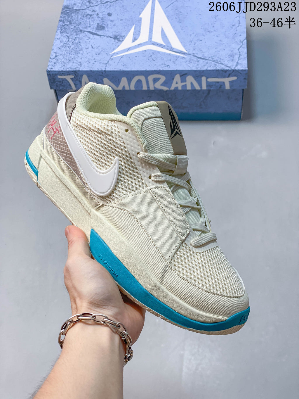 Cream Nike Ja 1 EP shoe with white side logo and bright blue outsole accents.